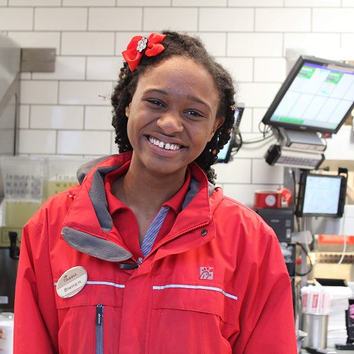 Happy employee serving inside Chick-fil-A